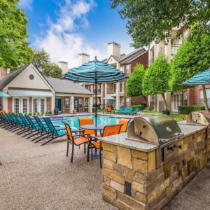 Built in grilling stations at the pool with brightly colored patio furniture